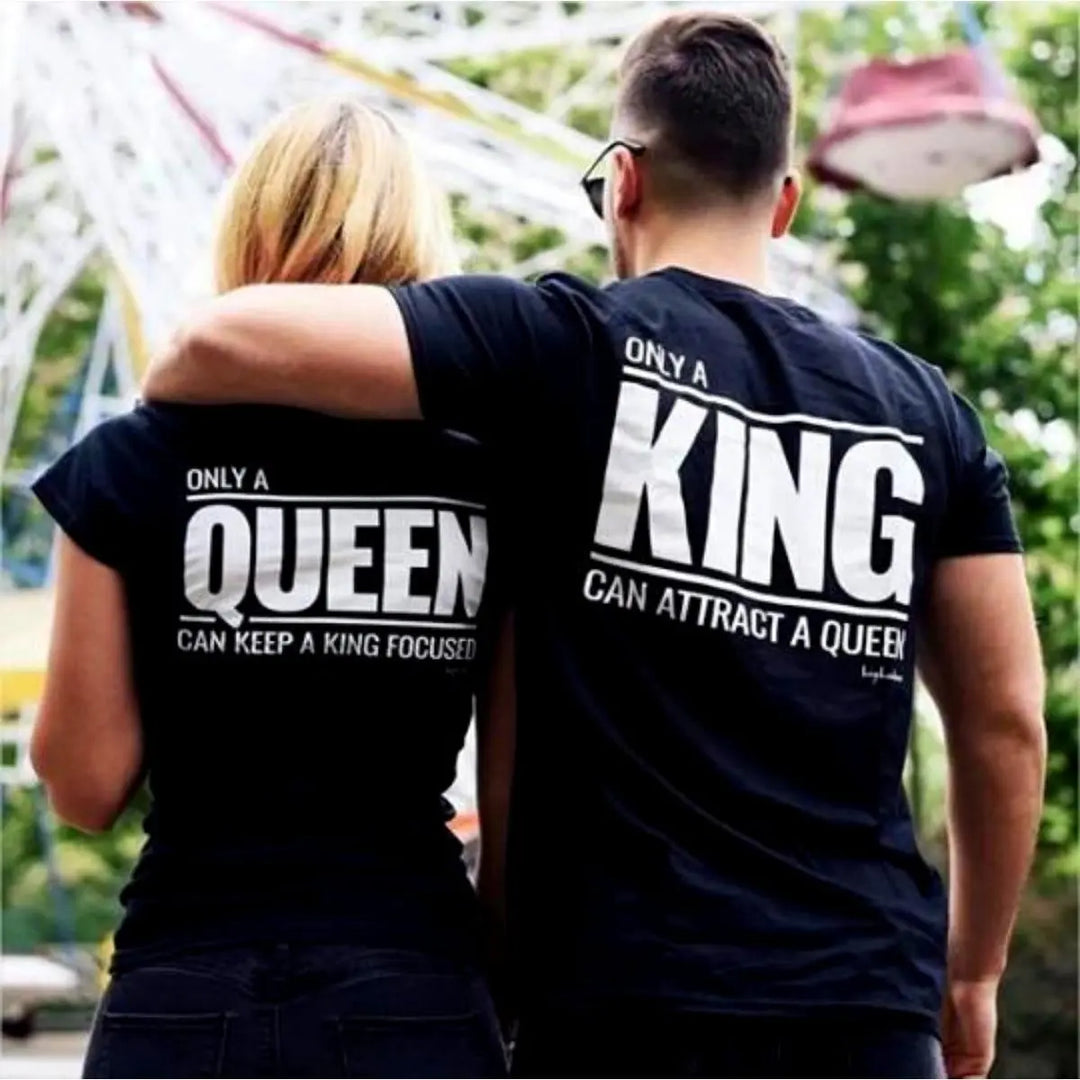 Matching black couple shirts—his says 'Only a King Can Attract a Queen,' hers reads 'Only a Queen Can Keep a King Focused.' A bold, empowering duo from CouplesChoices.com celebrating royalty in love.