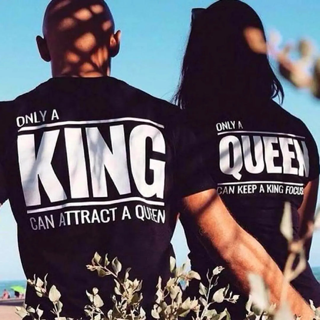 Matching black couple shirts—his says 'Only a King Can Attract a Queen,' hers reads 'Only a Queen Can Keep a King Focused.' A bold, empowering duo from CouplesChoices.com celebrating royalty in love.