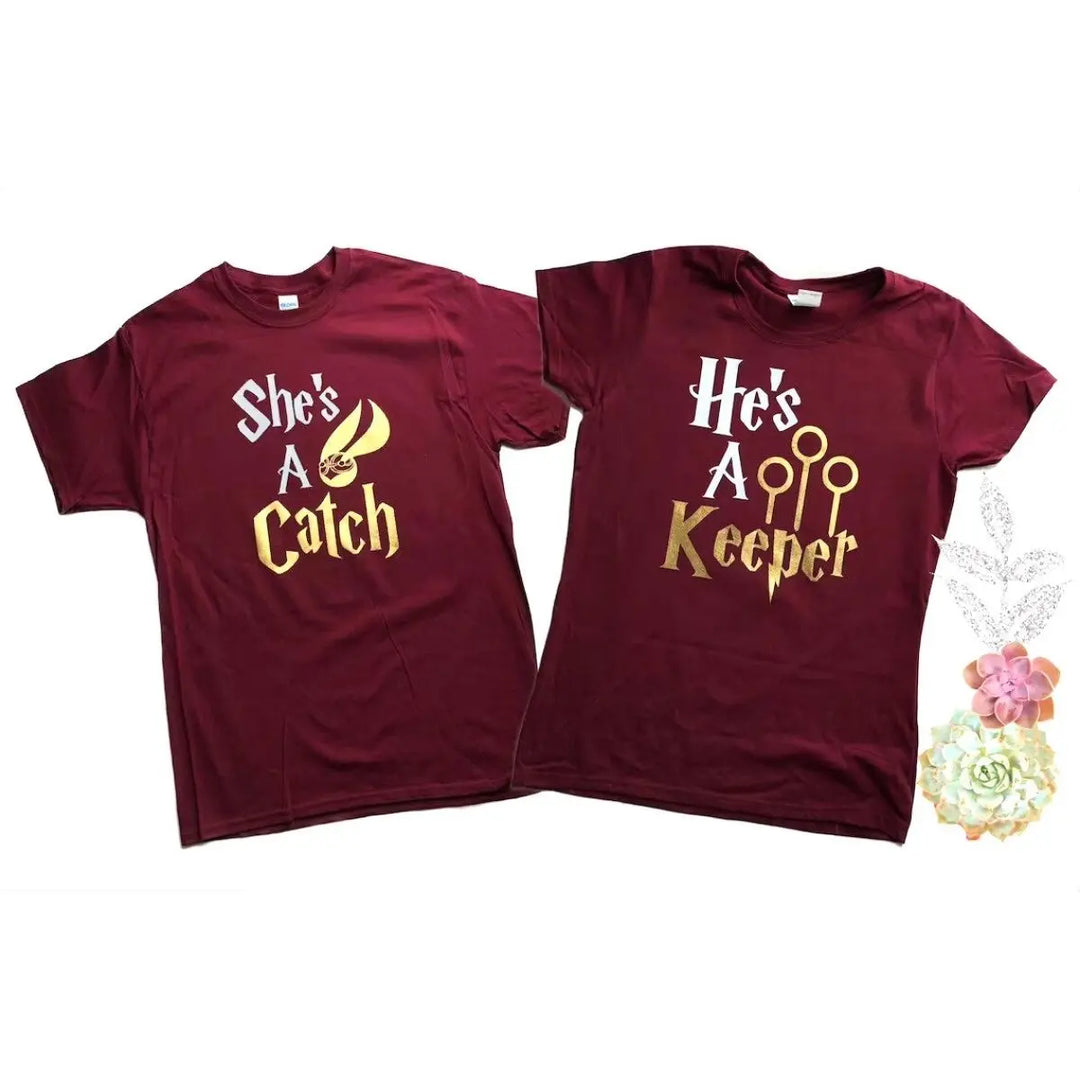 Matching maroon couple shirts with gold foil text: 'She’s a Catch' featuring a golden snitch, and 'He’s a Keeper' with Quidditch goalposts – perfect for Potterhead pairs.