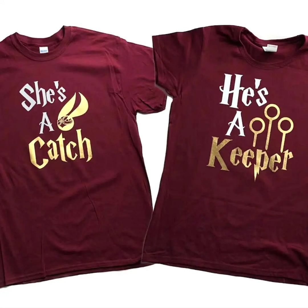 Matching maroon couple shirts with gold foil text: 'She’s a Catch' featuring a golden snitch, and 'He’s a Keeper' with Quidditch goalposts – perfect for Potterhead pairs.