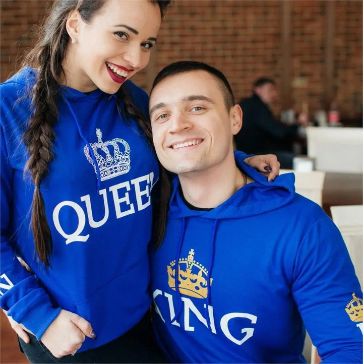 Royal blue matching couple hoodies from CouplesChoices.com featuring bold white “KING” and “QUEEN” lettering with crown graphics on the chest, sleeves, and hood. A stylish, statement-making set for couples who reign in love and unity.