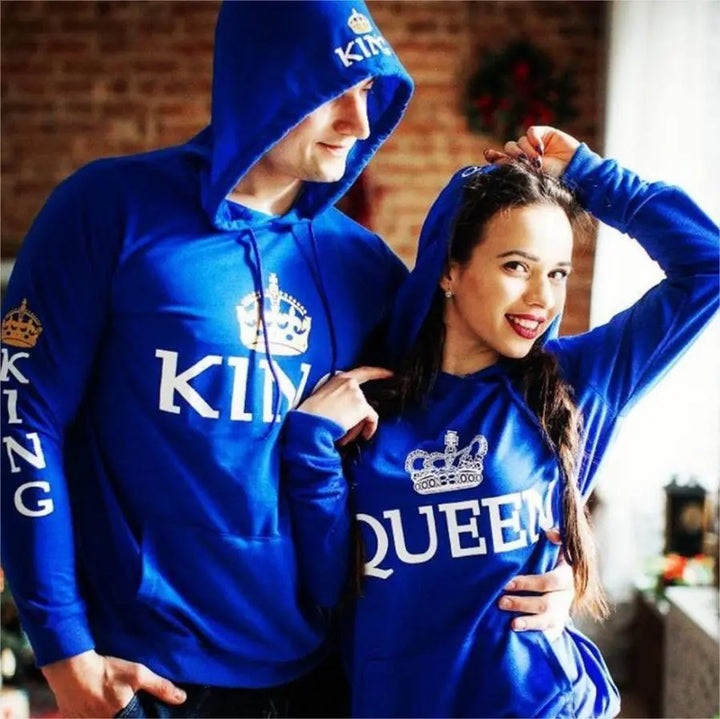 Royal blue matching couple hoodies from CouplesChoices.com featuring bold white “KING” and “QUEEN” lettering with crown graphics on the chest, sleeves, and hood. A stylish, statement-making set for couples who reign in love and unity.
