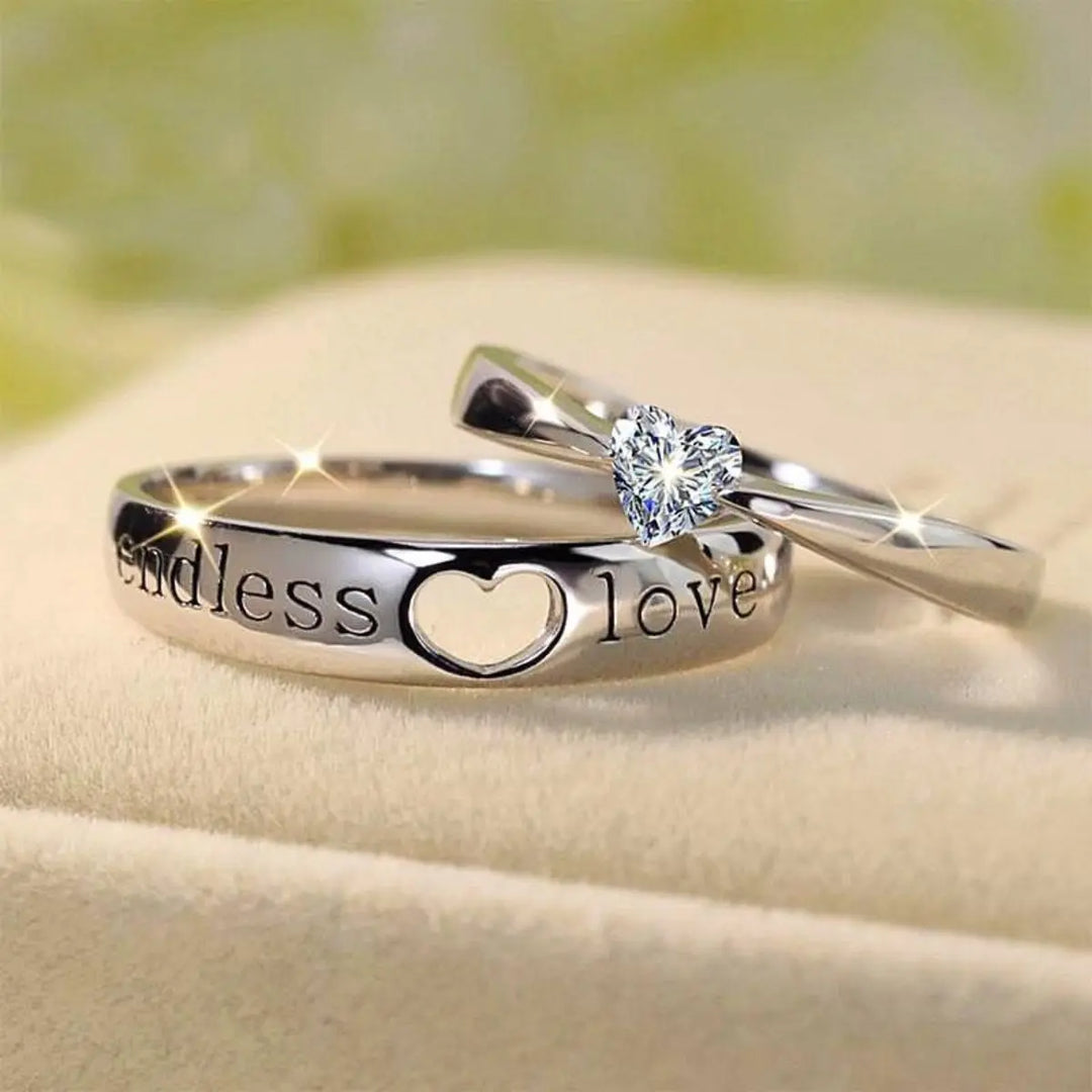 The Endless Love Rings from CouplesChoices.com feature elegant silver bands engraved with “endless love,” crowned by a heart-cut stone—perfectly symbolizing a forever bond built on devotion, simplicity, and timeless romance.